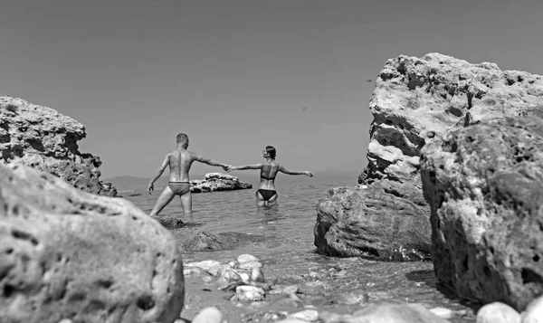 Couple in love relax on beach. Family and valentines day. Love relations of couple enjoying summer day together. Summer holidays and travel vacation. Sexy woman and man stand in sea water. — Stock Photo, Image