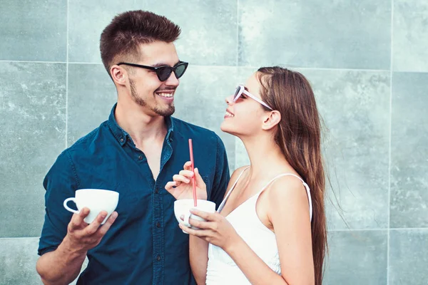 A coffee order says a lot about him. Couple in love drink coffee outdoor. Couple of woman and man with coffee cups. Girlfriend and boyfriend have espresso drink. Enjoying the best coffee date