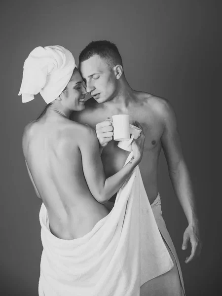 Morning coffee, woman and man in bath towel.