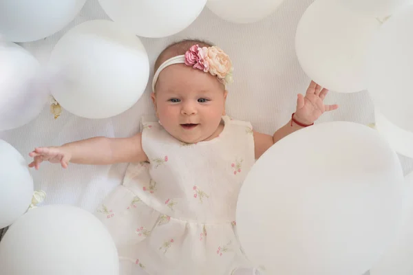 I love my baby. Family. Child care. Childrens day. Small girl. Happy birthday. Childhood happiness. Portrait of happy little child in white balloons. Sweet little baby. New life and birth