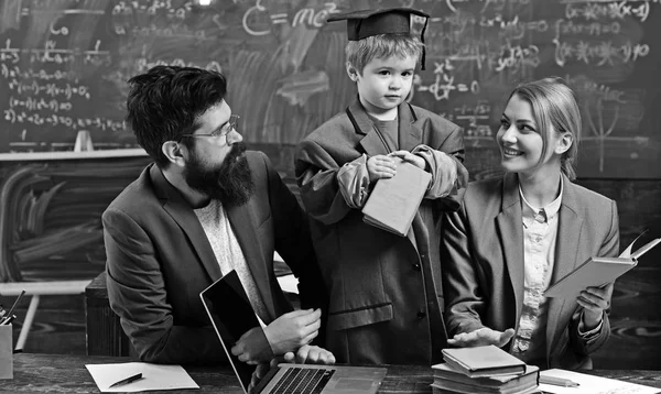 Little child play school with woman and man. Genius son read book for mother and father students. Family study together at desk with laptop. Back to school. Knowledge and reading concept — Stock Photo, Image