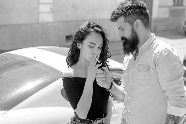 Smoking break. Romantic couple have cocktail date. Couple in love date on street. Pretty woman and bearded man smoke and drink outdoor. Smoking and alcohol addiction. Bad habit and addiction