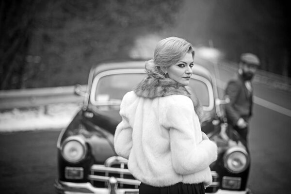limousine car with driver and sexy lady in fur coat. limousine car in retro style with couple in love.