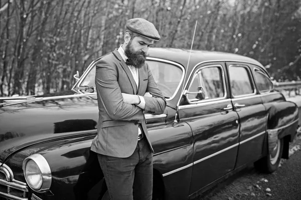 Call boy in vintage auto. Bearded man in car. Escort man or security guard. Retro collection car and auto repair by mechanic driver. Travel and business trip or hitch hiking — Stock Photo, Image