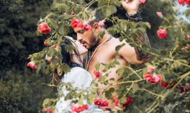 Passion love couple in the garden. Romantic moment. Handsome muscular guy and amazing sexy woman. Cosmopolitan couple. clipart
