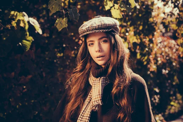 Fashion autumn portrait woman with yellow maple leaves on Nature Background. Fall concept. Autumn Park. Autumn woman in autumn park with red pullover.