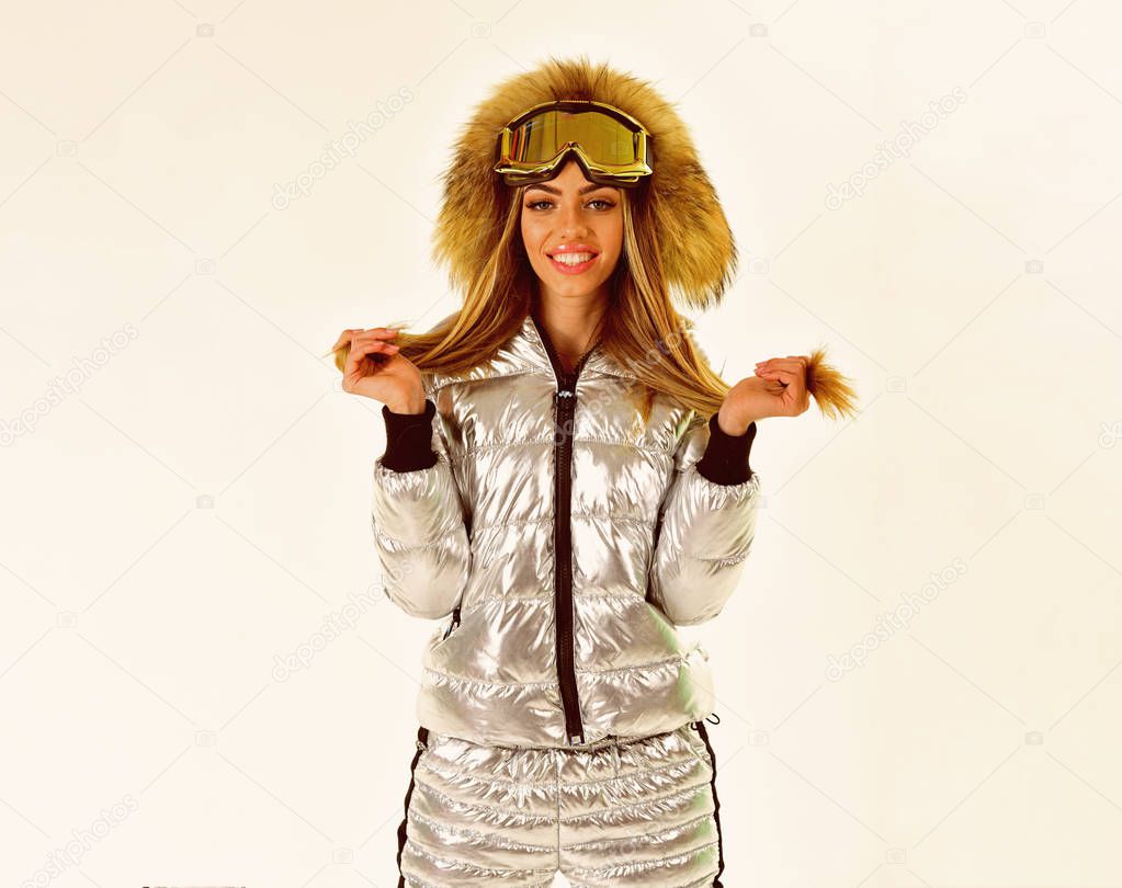 Beaming woman. It is so cold. Happy holidays. Ski resort and snowboarding. Winter sport and activity. Ski boots and glasses. Girl in ski or snowboard wear. Sexy woman in winter clothes
