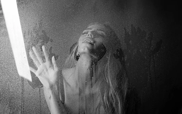 Fashion beauty and love. Rain drops on window glass in heart shape. Window with water drops before girl with makeup. Sexy woman behind plastic sheet with water drops. Shower and hygiene spa treatment — Stock Photo, Image