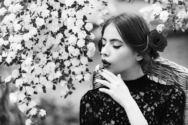 Flicka med vit blomma i munnen på vackert ansikte — Stockfoto