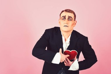 Act like being deep in love. Mime man celebrate valentines day. Mime actor has valentines celebration party. Comedian actor hold red heart. Love confession. Happy valentines day clipart