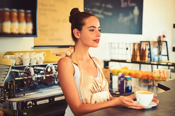 The coffee that inspires. Barista serve cup of hot coffee drink with smile. Brewing coffee in coffeehouse. Woman barista in coffee shop. Pretty woman stand behind cafe counter