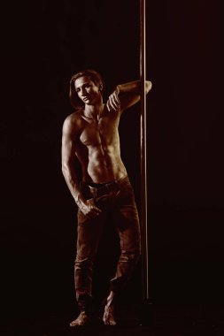 Atletik erkekleri pilon üzerinde akrobatik öğeleri gösteriyor. Güçlü dansçı egzersiz kutup. Özgürlük. Pilon üzerinde dans gümüş gövde sanat kaslı adam. Metal yüzey ile seksi maço. Pole dans spor.