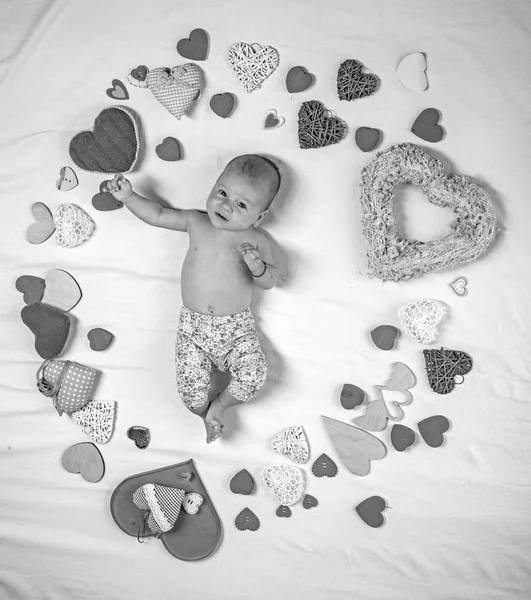 Pleasant timespending. Love. Portrait of happy little child. Sweet little baby. New life and birth. Family. Child care. Small girl among red hearts. Childhood happiness.Valentines day — Stock Photo, Image