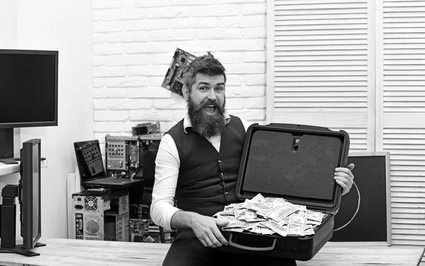 Rich and successful. Bearded man with cash money. Business man with money case in office. Bearded hipster with dollar banknotes. Business and making money. Withdrawing cash from electronic money