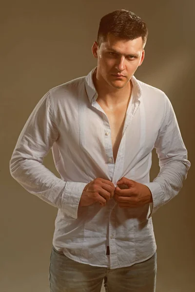 남자 유행 셔츠 unbutton. 젊은 사나이 옷 흰색 셔츠입니다. 심각한 얼굴을 가진 남자입니다. 우아한 캐주얼 스타일으로 섹시 모델입니다. 패션 스트립 및 스타일 개념 — 스톡 사진