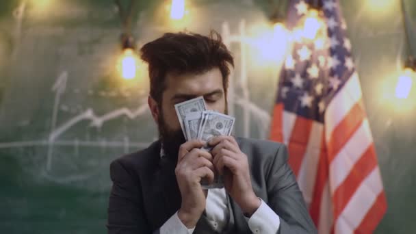 Smell of money. Easy cash loans. Man formal suit hold pile of dollar banknotes on background of USA flag. Businessman got cash money. Richness and wellbeing concept. Get cash money easy and quickly. — Stock Video