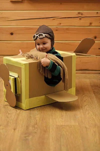 Young boy pilot flying a cardboard box — Stock Photo, Image