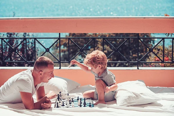 Summer vacation of happy family. summer vacation of father and son play chess. — Stock Photo, Image
