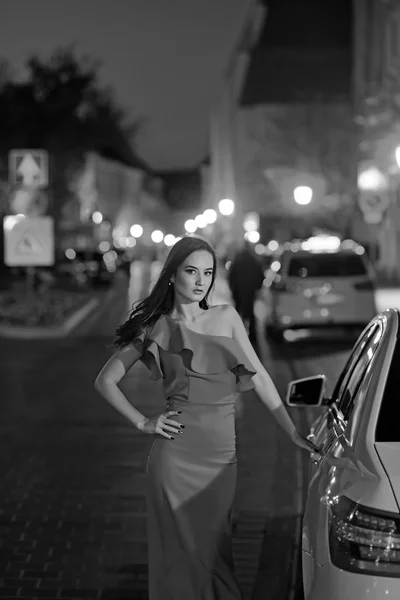 Young Beauty Famous Woman In Red Dress Outdoor at taxi car.
