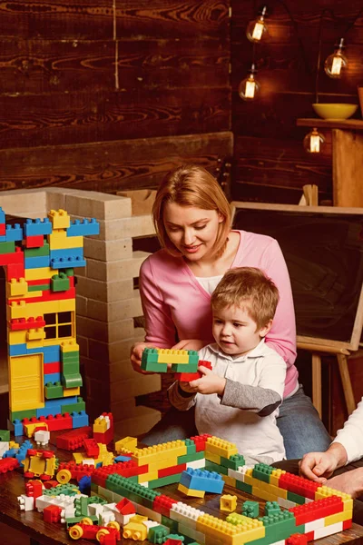 Mother concept. Mother and son play toy bricks. Mother and child building structure model with blocks. My mother is wonderful. Mothers day