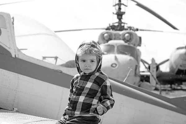 Its time to fly. Little kid have summer vacation. Cute boy child on vacation trip. Little child at helicopter field. Helicopter tour and travel. Air travel. Enjoying summer travel. Travelling by air