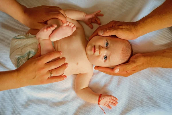 Newborn gymnast. Dynamic gymnastics for childrens health. Gymnastics for newborn baby with massage elements. Pediatric massage for infant baby. Massage stimulates childrens physical growth — Stock Image Newborn gymnast. Dynamic gymnastics for childrens health. Gymnastics for newborn baby with massage elements. Pediatric massage for infant baby. Massage stimulates childrens physical growth Stock Photo