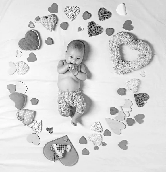 Live in love. Family. Child care. Small girl among red hearts. Sweet little baby. New life and birth. Love. Portrait of happy little child. Childhood happiness.Valentines day — Stock Photo, Image