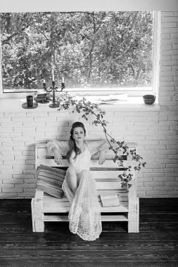 Romantik yazar adlı şiir kitabı. Güzellik ve moda vintage tarzı bak. Güzel kız beyaz gelinlik ve retro saç modeli. Moda kadın modeli kitap okumak. bahar ya da yaz kız bankta sakin ol