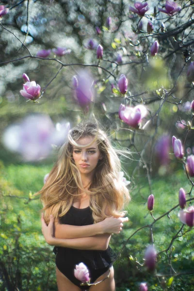 Sexig naturlig skönhet. Kvinnan i svart underkläder. Magnolia. Trädgård. Tidskriften parfym. — Stockfoto