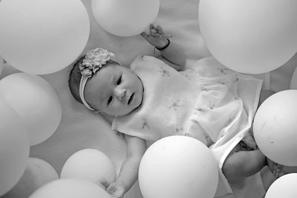 Sleepy baby. Childhood happiness. Sweet little baby. New life and birth. Family. Child care. Childrens day. Small girl. Happy birthday. Portrait of happy little child in white balloons