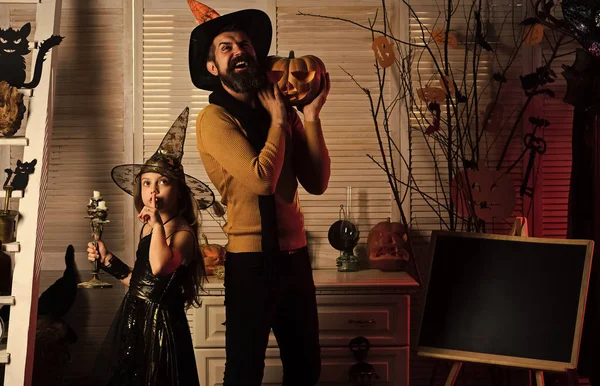 Wizard and little witch hold big jack o lantern — Stock Photo, Image
