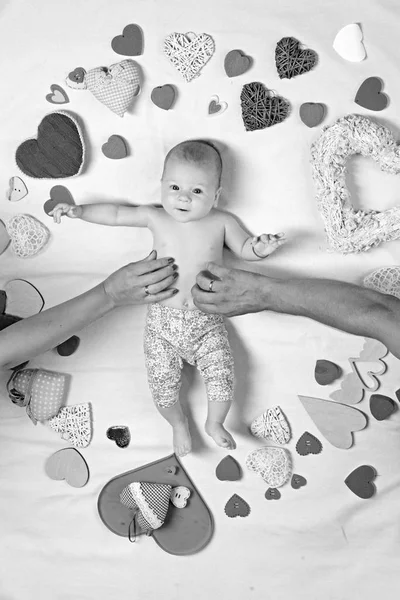 Love and trust. Becoming a family. Childhood happiness.Valentines day. Love. Portrait of happy little child. Small girl among red hearts. Sweet little baby. New life and birth. Family. Child care — Stock Photo, Image