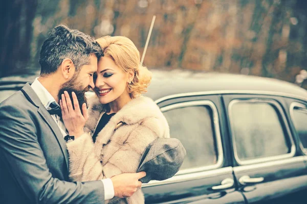 retro look of couple in love. retro car and happy couple in love outdoor.