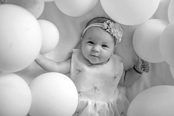 Ik wil spelen. Portret van gelukkig klein kind in witte ballonnen. Lieve kleine baby. Nieuw leven en geboorte. Familie. Kinderopvang. Kinder dagen. Klein meisje. Proficiat met je verjaardag. Jeugd geluk — Stockfoto