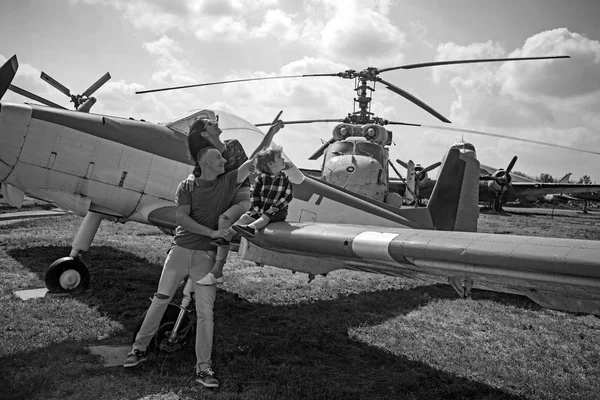 Wings are for flying. Woman and man with boy child at helicopter. Happy family vacation. Family couple with son on vacation travel. Enjoying travelling by air. Air tour and travel