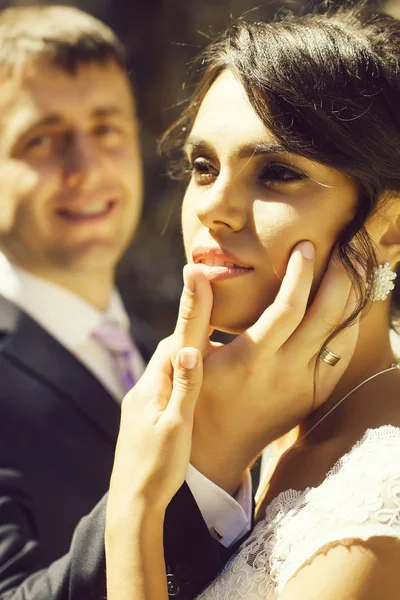 Groom hand on bride face