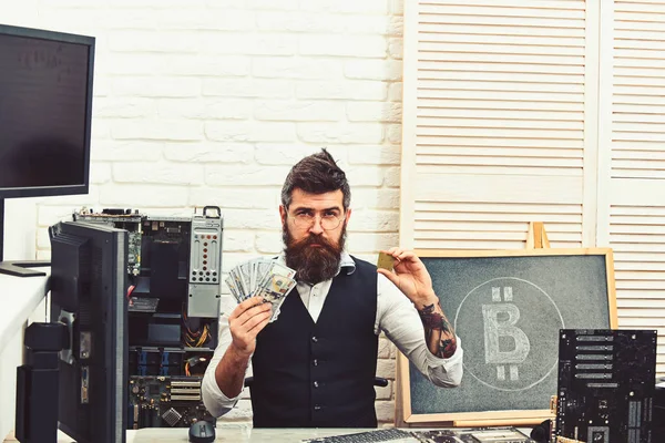 Crypto currency mining hardware. Bitcoin miner man in server room. Bearded man bitcoiner. Bearded businessman with computer circuits and dollars. Virtual or digital currency. Mining bitcoin cash