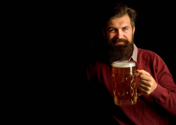 Bearded man with a glass of beer. Beer Types and Styles. Brewer. Beer. Germany - Bavaria. Stylish handsome man in black suit drinking beer over Black background.