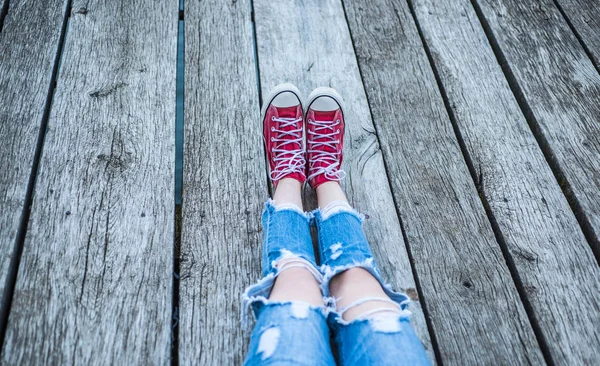 Red sneakers. White shoelaces on red sneakers. Comfortable shoes. Trends concept. — Stock Photo, Image