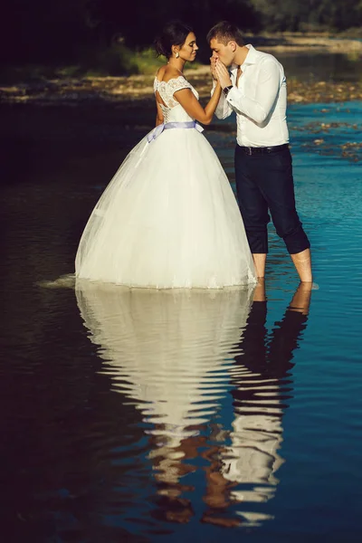 couple kissing in river water