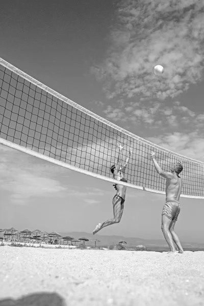 Vacaciones de verano y viajes de vacaciones en Miami. Mujer sexy y hombre musculoso con bola en la red. Amor y coqueteo de pareja. Pareja en el amor jugar voleibol en la playa soleada. Actividad deportiva y salud —  Fotos de Stock