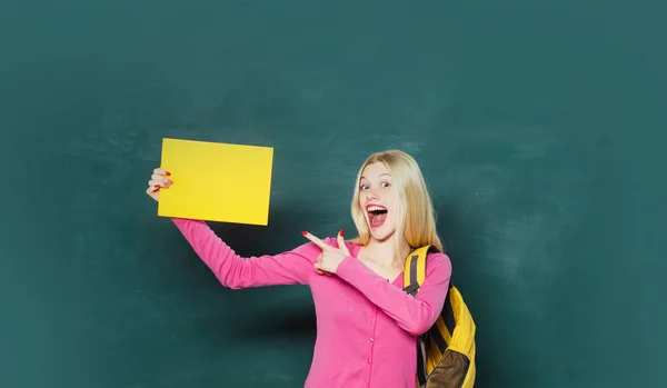 Student with backpack. High school education. Great opportunity. Looking for volunteers. Formal education. Improving myself through education. Happy girl holding announcement while stand in classroom — Stock Photo, Image