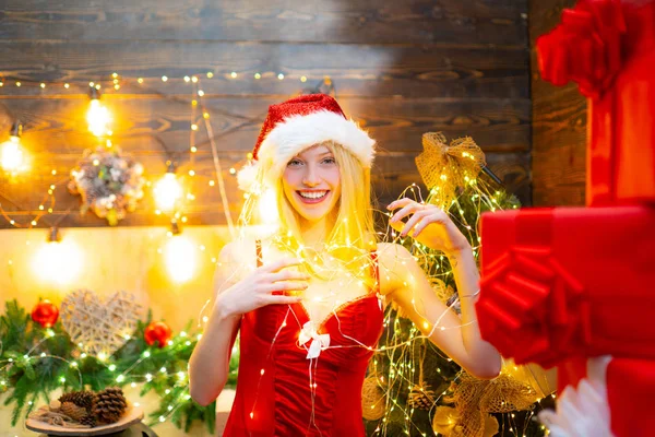 Lot of lights. Love peace and joy for whole year. Girl santa hat christmas party. Girl celebrate new year and merry christmas. Warm light of christmas garland. Magic moment. Christmas celebration