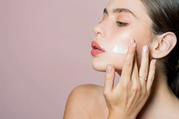 Skin cream concept. Facial care for female. Keep skin hydrated regularly moisturizing cream. Fresh healthy skin concept. Taking good care of her skin. Beautiful woman spreading cream on her face — Stock Photo, Image
