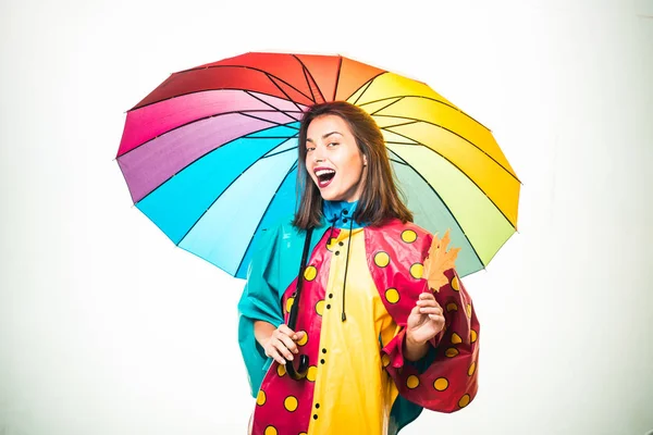 Surprise woman playing with leaves and looking at camera. Autumn mood and the weather are warm and sunny and rain is possible. Autumn concept. Girl in autumn are getting ready for autumn sale.