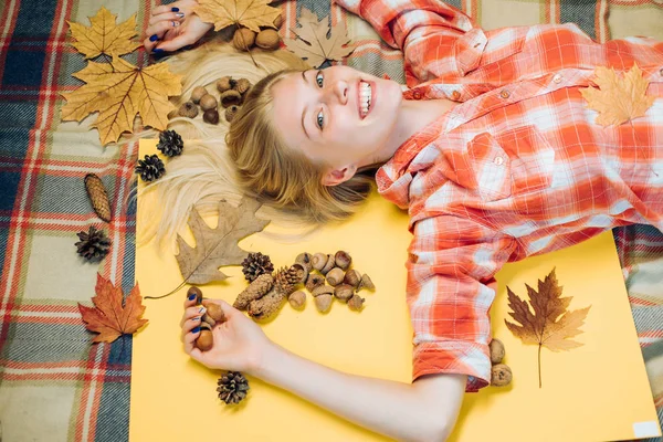 Beautiful girl with background board for Copyspace. Happy young woman preparing for autumn sunny day. Attractive young woman wearing in fashionable seasonal clothes having Autumnal mood. Fashion girls