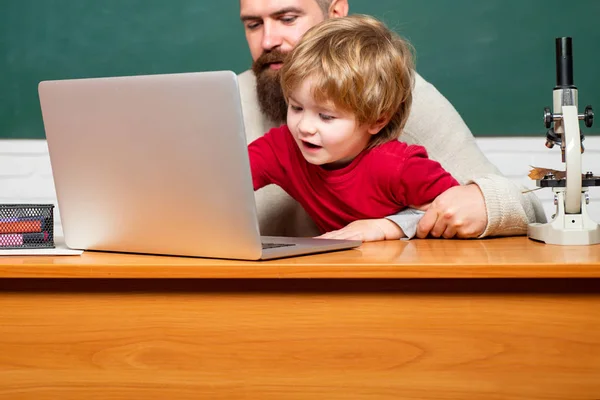 Teacher and child. Happy family - daddy and son together. Chalkboard background. Childhood and parenthood. Dad son are concentrated on the problem. Parent Teacher. — Stock Photo, Image