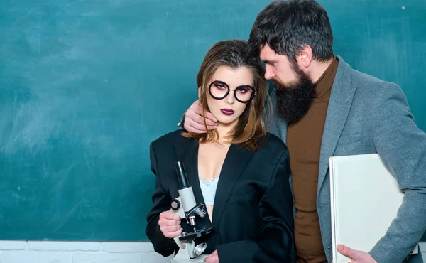 Sexy female student pointing at chalkboard. Workplace romance of handsome man and sexy woman in university. Friendship and good warm relations concept. Love romance seduction dating. — Stock Photo, Image