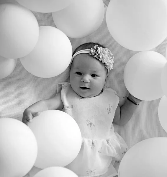 Happy birthday. Family. Child care. Childrens day. Small girl. Happy birthday. Portrait of happy little child in white balloons. Childhood happiness. Sweet little baby. New life and birth — Stock Photo, Image