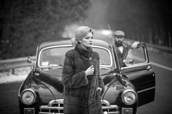 nostalgia concept. nostalgia and retro car at bearded man and woman in coat.